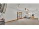 Bright living room with ceiling fan and glass doors leading outside, view to kitchen at 1910 Clubhouse Rd, Lakeland, FL 33813