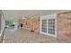 Spacious covered patio features brick flooring and multiple seating options for outdoor enjoyment at 1910 Clubhouse Rd, Lakeland, FL 33813