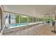 Screened-in patio overlooking a sparkling pool with an adjacent seating area at 1910 Clubhouse Rd, Lakeland, FL 33813