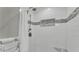 Modern shower featuring white subway tiles, mosaic accents, and bronze fixtures at 1910 Clubhouse Rd, Lakeland, FL 33813