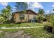 Home exterior featuring spacious backyard, side yard access and stepping stone walkway at 1927 E Main St, Lakeland, FL 33801