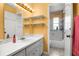 Bright bathroom with white vanity, shelves, and shower/tub combo at 1927 E Main St, Lakeland, FL 33801