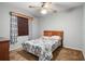 Bedroom with patterned bedspread, window, and carpet flooring at 1927 E Main St, Lakeland, FL 33801
