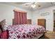 Comfortable bedroom featuring a floral comforter and wood dresser at 1927 E Main St, Lakeland, FL 33801