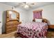 Charming bedroom boasts a decorative mirror, dresser, and floral comforter at 1927 E Main St, Lakeland, FL 33801