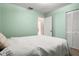 Bright bedroom featuring pastel walls, closet, doorway, and comfortable bed at 1927 E Main St, Lakeland, FL 33801