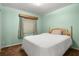 Bedroom with green walls and patterned curtains at 1927 E Main St, Lakeland, FL 33801