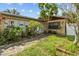 Charming home featuring lush landscaping, stone walkway and secure front door at 1927 E Main St, Lakeland, FL 33801