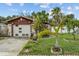 Charming home featuring a one-car garage and lush tropical landscaping at 1927 E Main St, Lakeland, FL 33801