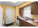 Traditional kitchen with wood cabinets, white appliances, and a double sink at 1927 E Main St, Lakeland, FL 33801