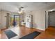 Living room with wood floors, ceiling fan, hutch and glass doors to outdoor patio at 1927 E Main St, Lakeland, FL 33801