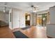 Open-concept living room with hardwood floors, ceiling fan, and glass doors to patio at 1927 E Main St, Lakeland, FL 33801