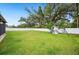 Spacious backyard features a large green lawn and a swing set at 2110 Bristol Ave, Lakeland, FL 33803