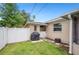 Fenced backyard with a grill and access gate at 2110 Bristol Ave, Lakeland, FL 33803