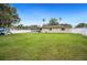 Expansive backyard boasting a lush green lawn, enclosed patio, and play equipment at 2110 Bristol Ave, Lakeland, FL 33803