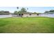 Spacious backyard featuring a well-maintained lawn, white fence, and screened-in patio at 2110 Bristol Ave, Lakeland, FL 33803