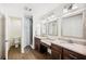 Bright bathroom features dual sinks, granite counters, and a glass-enclosed shower at 2110 Bristol Ave, Lakeland, FL 33803