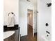 Bathroom featuring a tiled shower with a sleek black shower head, complemented by a dark granite vanity top at 2110 Bristol Ave, Lakeland, FL 33803