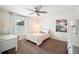 Cozy bedroom featuring soft carpet, a ceiling fan, and natural light from the window at 2110 Bristol Ave, Lakeland, FL 33803