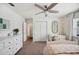 Bright bedroom offering plush carpet, a ceiling fan, and natural light from the window at 2110 Bristol Ave, Lakeland, FL 33803