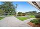 Long driveway leading to a well-maintained home with mature trees and landscaping at 2110 Bristol Ave, Lakeland, FL 33803