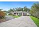 Charming single-story home featuring a well-manicured lawn, large driveway, and inviting entrance at 2110 Bristol Ave, Lakeland, FL 33803