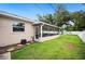 Exterior back view of the home, showcasing screened-in lanai and fenced yard at 2110 Bristol Ave, Lakeland, FL 33803
