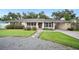 Charming single-story home featuring a well-maintained front yard with a stone walkway and lush landscaping at 2110 Bristol Ave, Lakeland, FL 33803