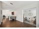 Hallway with hardwood floors leading to the dining room and Gathering room, with a bench to the side at 2110 Bristol Ave, Lakeland, FL 33803