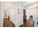 Long hallway with hardwood flooring leading to dining room and other rooms at 2110 Bristol Ave, Lakeland, FL 33803