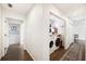 Hallway view featuring a laundry nook with washer, dryer, and wood shelving at 2110 Bristol Ave, Lakeland, FL 33803