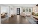 Inviting living room with stylish wood floors, a modern front door, and large window with backyard views at 2110 Bristol Ave, Lakeland, FL 33803