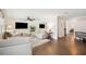 Open-concept living room with hardwood floors, neutral decor, and views into adjacent dining and Gathering rooms at 2110 Bristol Ave, Lakeland, FL 33803