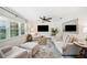 Bright living room featuring neutral furniture, a large window with natural light, and a ceiling fan at 2110 Bristol Ave, Lakeland, FL 33803