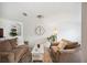 Cozy living room with comfortable seating, built-in shelving, and a large decorative wall clock at 2110 Bristol Ave, Lakeland, FL 33803