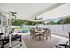 Enclosed patio has an outdoor dining set, ceiling fan, and exercise equipment at 2110 Bristol Ave, Lakeland, FL 33803