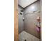 Tiled walk-in shower featuring stone accents, built-in shelving, and modern fixtures, offering a luxurious bathing experience at 2110 Bristol Ave, Lakeland, FL 33803