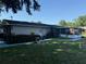 Spacious backyard featuring a screened porch, shed, and privacy fence at 2424 Bates Sw Ave, Winter Haven, FL 33880