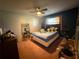 Cozy bedroom with a ceiling fan, a window with blinds, and ample space for furniture at 2424 Bates Sw Ave, Winter Haven, FL 33880