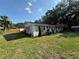 Charming single-story home with manicured lawn, mature trees, and neutral stucco exterior at 2424 Bates Sw Ave, Winter Haven, FL 33880