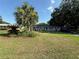 Landscaped front yard features a beautiful palm tree and a well-maintained lawn at 2424 Bates Sw Ave, Winter Haven, FL 33880