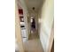 Hallway with neutral tile flooring connecting to kitchen and other rooms at 2424 Bates Sw Ave, Winter Haven, FL 33880