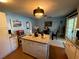 Bright kitchen with a granite-topped island, stainless steel appliances, and a dining area at 2424 Bates Sw Ave, Winter Haven, FL 33880