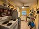 Kitchen with yellow walls and white appliances and a ceiling fan at 2424 Bates Sw Ave, Winter Haven, FL 33880