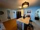 Well-lit kitchen featuring blue walls, granite countertop island, and modern appliances at 2424 Bates Sw Ave, Winter Haven, FL 33880