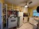 Kitchen featuring white appliances, plenty of cabinet space and ceiling fan at 2424 Bates Sw Ave, Winter Haven, FL 33880