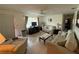Inviting living room featuring tile floors, ceiling fan, and a large window providing natural light at 2424 Bates Sw Ave, Winter Haven, FL 33880