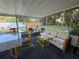 Enclosed porch features casual seating and views of the well-maintained backyard at 2424 Bates Sw Ave, Winter Haven, FL 33880