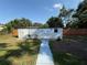 Backyard features a white shed with decorative elements and a painted walkway at 2424 Bates Sw Ave, Winter Haven, FL 33880