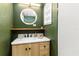 Modern bathroom featuring a stylish vanity with a marble countertop and a round LED mirror at 2711 Crutchfield Rd, Lakeland, FL 33805